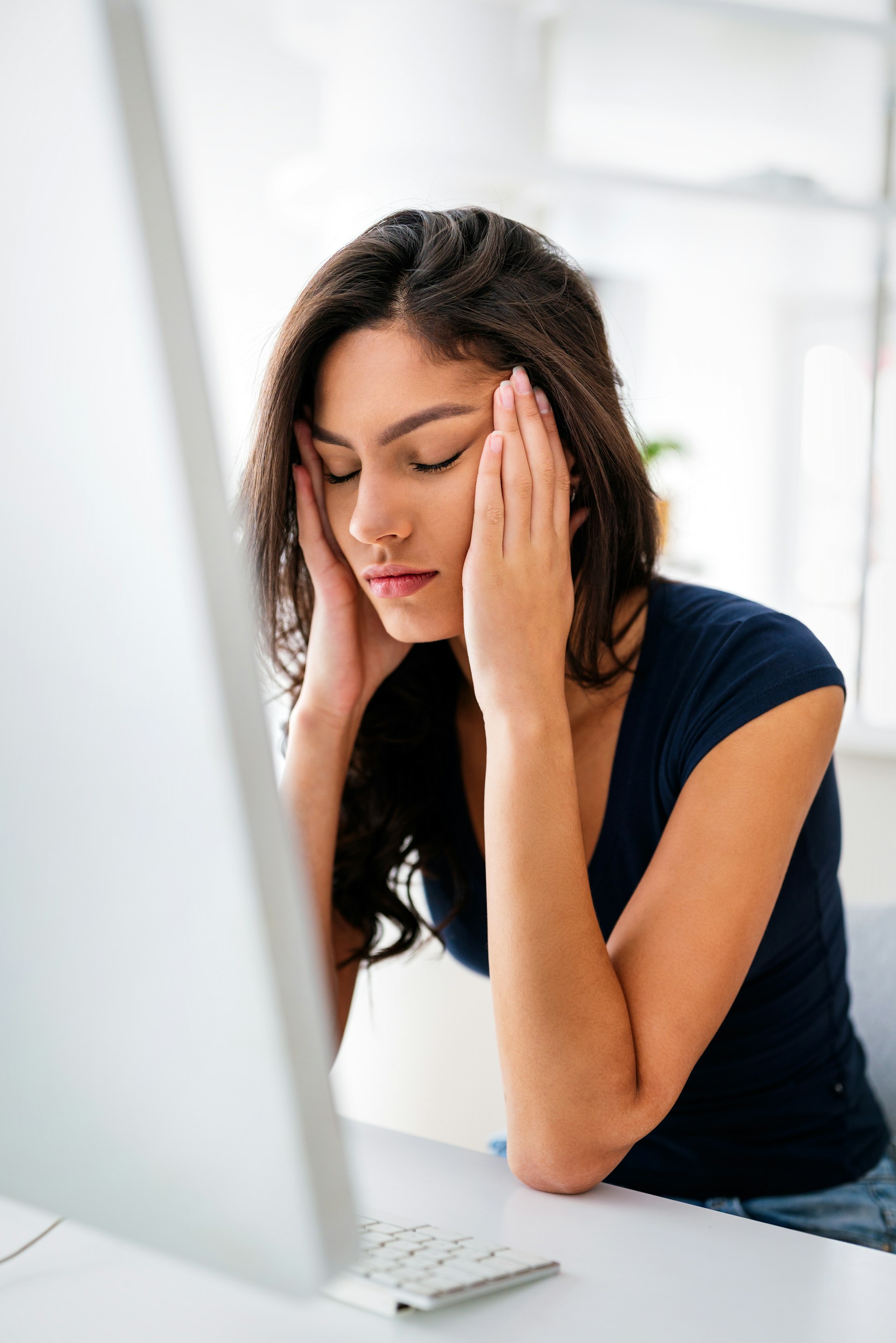 A young woman suffering from a migraine