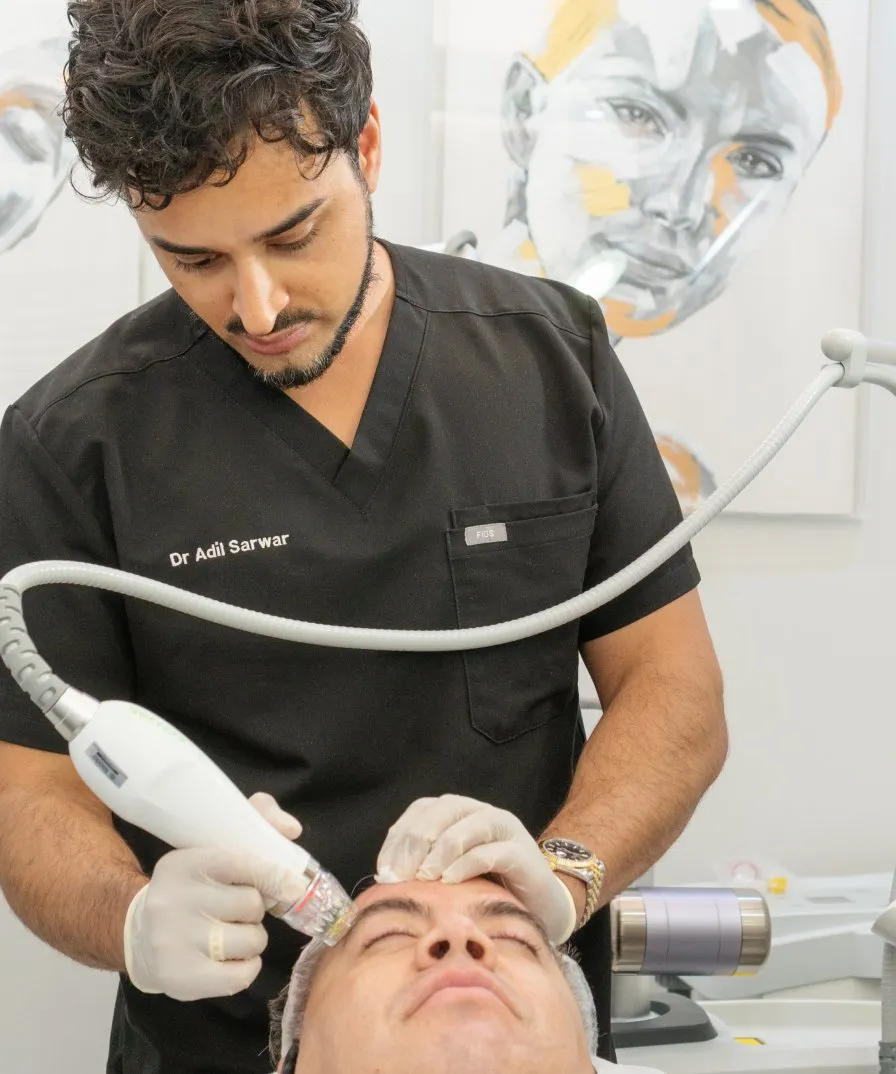 Dr Adil Sarwar delivering RF microneedling treatment in London