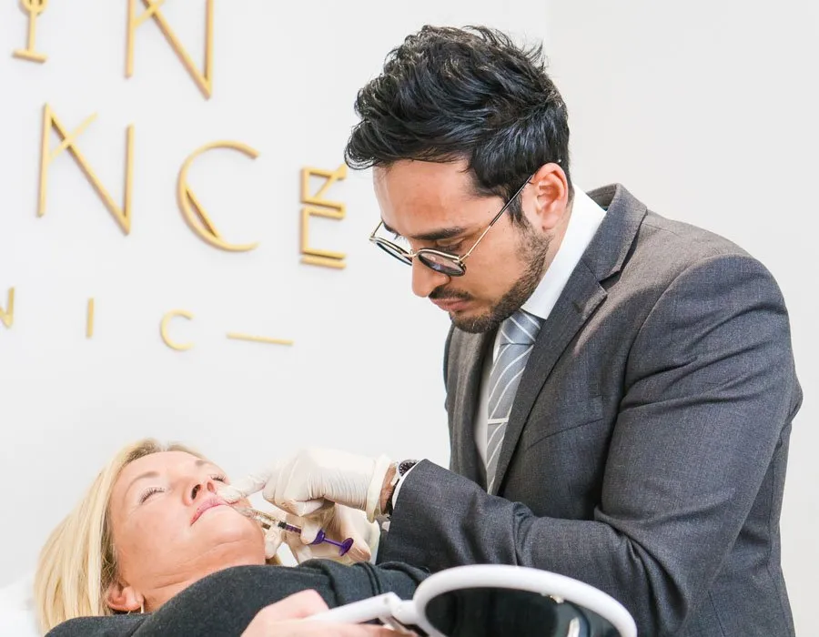 Dr Adil injecting Botox into a woman's lip at Skin Science Clinic in London