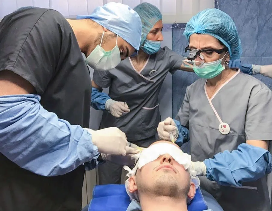 Dr Adil in surgery for a PRP hair transplant at Skin Science Clinic