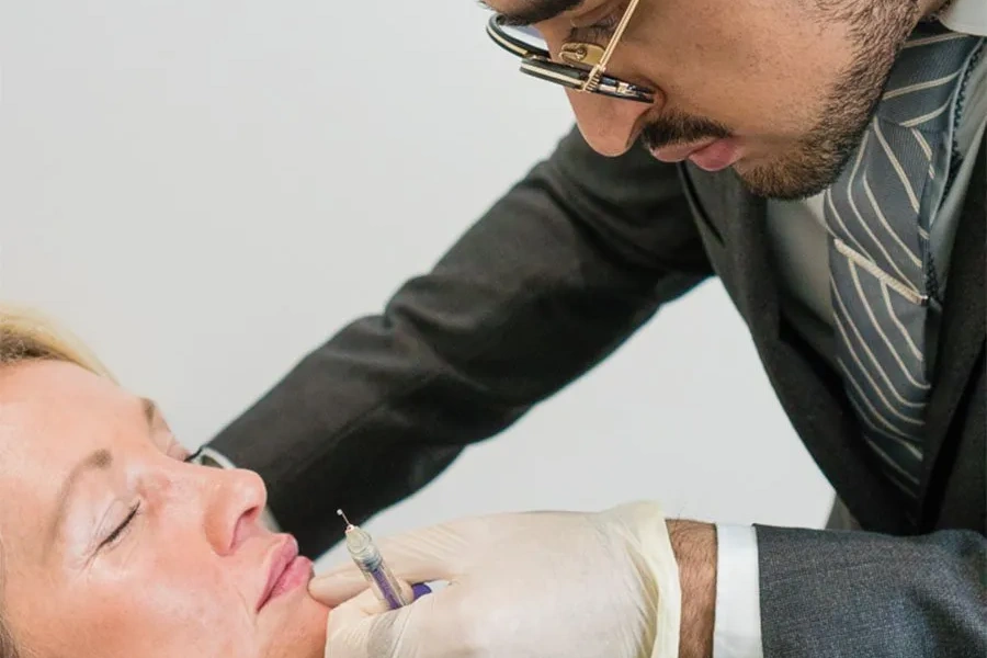 Non-surgical nose filler being administered