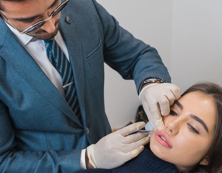 Dr Adil Sarwar demonstrating a dermal filler injection during training