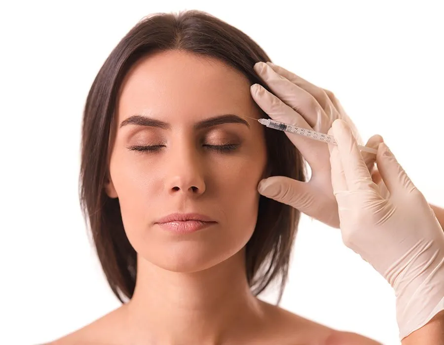 Woman having Botox injected in the eyebrow at Skin Science Clinic in London