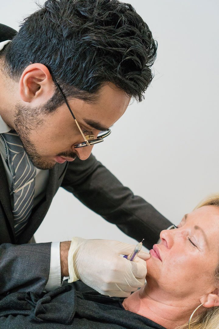 Dr Sarwar performing chin filler treatment