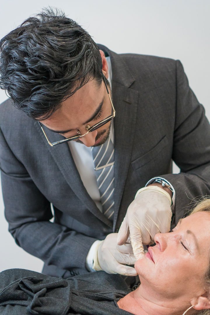 Dr Sarwar injecting dermal filler into the chin