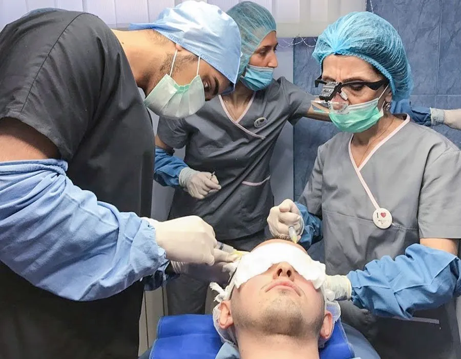Dr Adil Sarwar performing a hair transplant at Skin Science Clinic in London